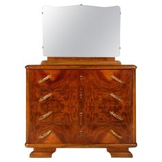 a wooden dresser with a mirror on it's top and two drawers in the middle