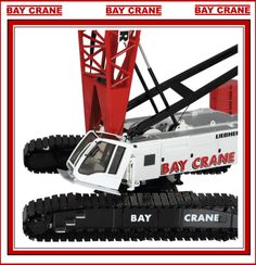 the toy crane is white and red with black lettering on it's front end