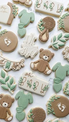 cookies decorated with teddy bears and leaves on a white tablecloth for baby's first birthday