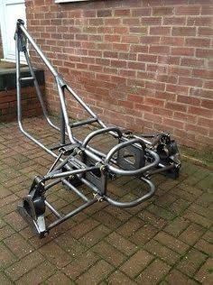 a small metal cart sitting on the side of a brick building