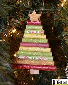 a christmas tree made out of books with a star hanging from it's top