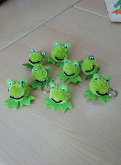 the froggy keychains have been made to look like they're smiling