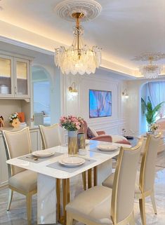 a dining room table and chairs with chandelier