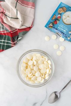 the ingredients to make this dessert include marshmallows in a glass bowl with spoon