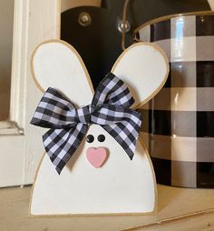 a wooden bunny with a bow on it's head