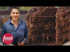 a woman standing in front of a pile of brownies