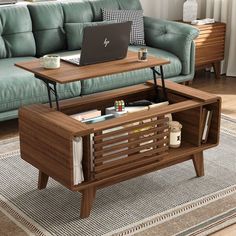 a coffee table with a laptop on it in front of a couch