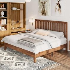 a bed sitting in a bedroom on top of a wooden floor next to a book shelf