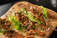 lettuce and chicken salad with sesame seeds on a wooden cutting board, ready to be eaten