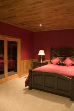 a bed room with a neatly made bed and two lamps on either side of the bed