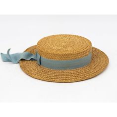 The Ridgemont Make's vintage 1930s boater hat showcases timeless elegance with its natural straw construction. Adorned with a pale blue ribbon and bow, this hat epitomizes classic style. The sturdy yet lightweight straw provides comfort and durability, while the charming ribbon adds a touch of sophistication. This boater hat captures the essence of vintage summer fashion, making it a coveted accessory for collectors and design enthusiasts alike. Seven are available for a display collection. Some Vintage Cream Boater Hat For Spring, Vintage Cream Boater Hat For Summer, Vintage Boater Hat, Vintage Straw Boater Hat With Flat Brim, Vintage Brown Brimmed Boater Hat, Blue Ribbon Bow, Vintage Summer Fashion, Straw Boater Hat, Straw Boater