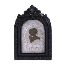 an ornate black frame with a silhouette of a woman on the front and back side