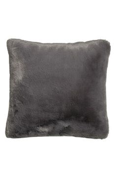 a gray pillow with fur on it