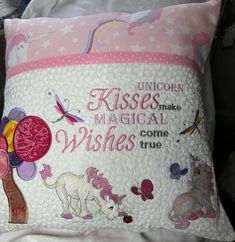 a pillow with unicorns and flowers on it that says unicorn kisses make mythical wishes come true