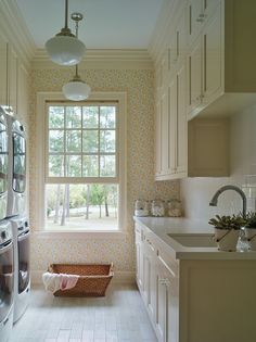 a kitchen with a window, sink and washer dryer in front of it