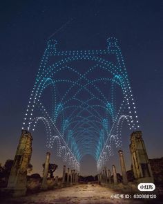 an arch in the sky with lights on it