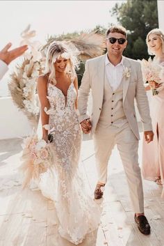 a bride and groom are walking down the aisle with their bouquets in hand as they leave