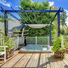 a hot tub sitting on top of a wooden deck