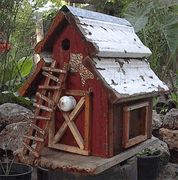 a small red shed with a ladder to the roof