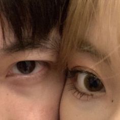 two people with brown eyes are looking at the camera