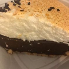 a piece of cake with chocolate and white frosting sitting on top of a plate