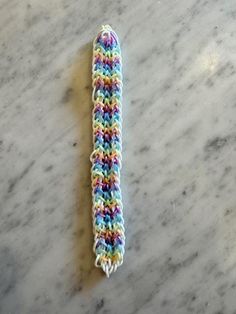 a crocheted toothbrush holder on a marble surface