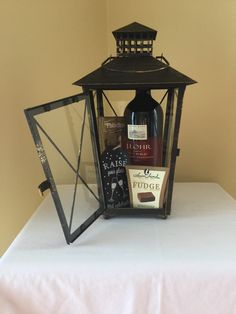 a bottle of wine sitting on top of a table next to a candle holder and mirror