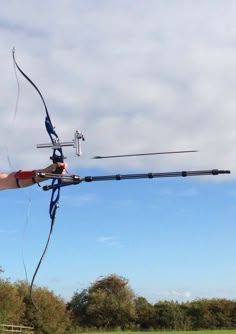 a man in red shirt flying a bow and arrow