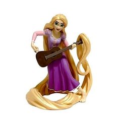 the figurine is holding a guitar and wearing a purple dress