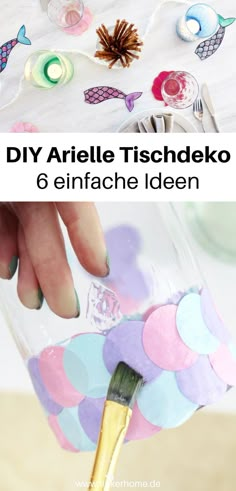 someone is painting the inside of a glass jar with acrylic paint on it