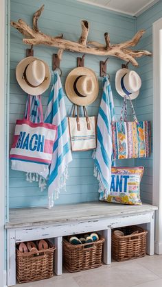 hats and beach towels are hanging on the hooks in this entryway area with baskets