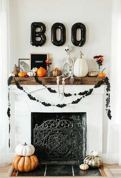 a fireplace decorated for halloween with black and white decorations