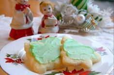 some green frosted cookies on a plate