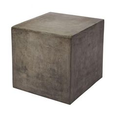 a square concrete box sitting on top of a white floor