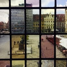 many different pictures are seen through the window panes in an old city street scene