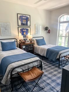 two beds in a room with blue and white carpet