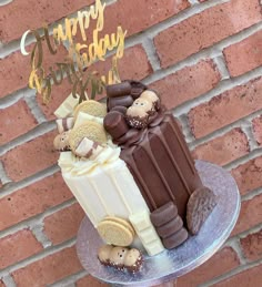 a birthday cake with chocolate and marshmallows is on a silver platter