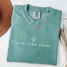 Are you a Jesus lover searching for the perfect gift? Look no further! Our faith-based apparel is designed to inspire and uplift those who follow Christ. Introducing our collection of faith-based shirts, a must-have for every Christian.  Product Info Comfort Colors Brand Shirt: 100% ring-spun cotton Care Instructions: Machine wash: cold (max 30C or 90F) Tumble dry: low heat Iron, steam or dry: medium heat Do not dry clean Production Time: Please allow 1 to 5 business days for production Delivery Jesus Loves You Shirts, Inspirational Crew Neck Top As Gift, Inspirational Letter Print Top As Gift, Green Letter Print Top As A Gift, Green Letter Print Top As Gift, Christian Wear, Christian Style, Bleach Shirt Diy, Christian Shirts For Women