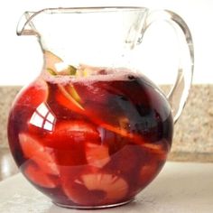 a pitcher filled with liquid sitting on top of a counter