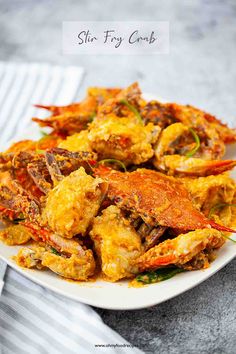 a white plate topped with cooked crabs on top of a table