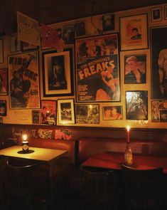 a dimly lit restaurant with posters on the wall