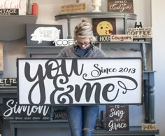 a woman holding a sign that says you came