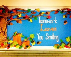 a bulletin board with fall leaves and pumpkins on it that says teamwork leaves you smiling