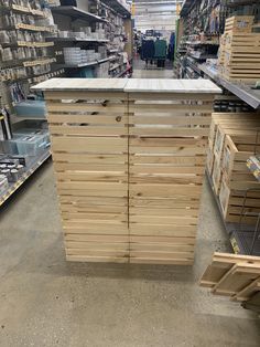 a large wooden counter in a store with lots of shelves and boxes on the floor