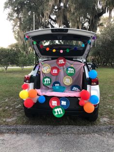 the trunk of a car decorated with balloons