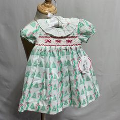 Edgehill Collection Pearly Gates Christmas Tree Smocked Girls Dress Size 3 Months Nwt Retail $80 The Sweetest Smocked Christmas Dress For Your Baby Girl! All Over Print With Smocking Across The Chest And Tie Bow In The Back. Includes Matching Diaper Cover. Smocked Christmas Dress, Smocked Christmas Dresses, Pearly Gates, Girls Smocked Dresses, Tie Bow, Diaper Cover, Sewing Project, Christmas Dress, Girls Dress