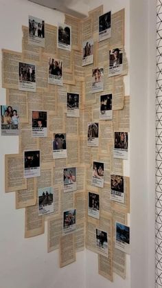 a wall with many pictures on it and some papers pinned to the wall behind it