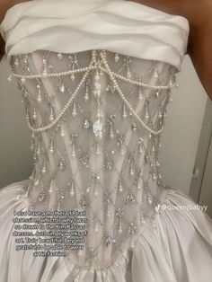 the back of a wedding dress with pearls on it