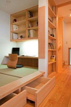 an empty room with wooden shelves and desks