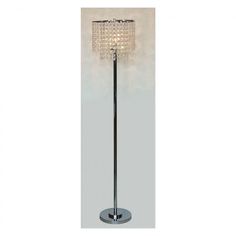 a chrome floor lamp with crystal cubes on the base and a round glass shade